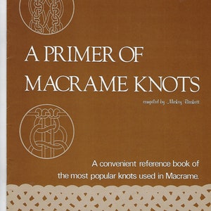 May include: A brown book cover with the title "A Primer of Macrame Knots" and the text "compiled by Mickey Baskett". The cover also features two illustrations of macrame knots.