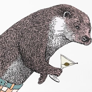 May include: A brown and black otter wearing a plaid shirt and holding a martini glass with an olive.