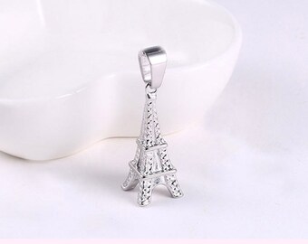 May include: Silver charm pendant featuring a detailed Eiffel Tower design. The charm is perfect for adding a touch of Parisian style to necklaces, bracelets, or keychains.