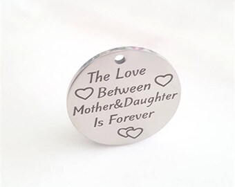 May include: Silver round charm with the text "The Love Between Mother & Daughter Is Forever" and hearts.