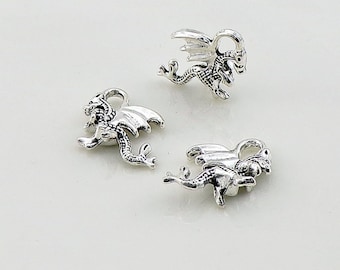 May include: Three silver dragon charms with wings and tails. The charms have a detailed design and are perfect for jewelry making or crafting.