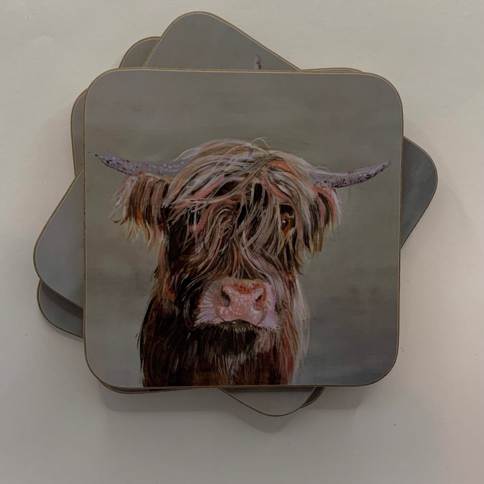 A set of four Highland Cow Coasters. Etsy
