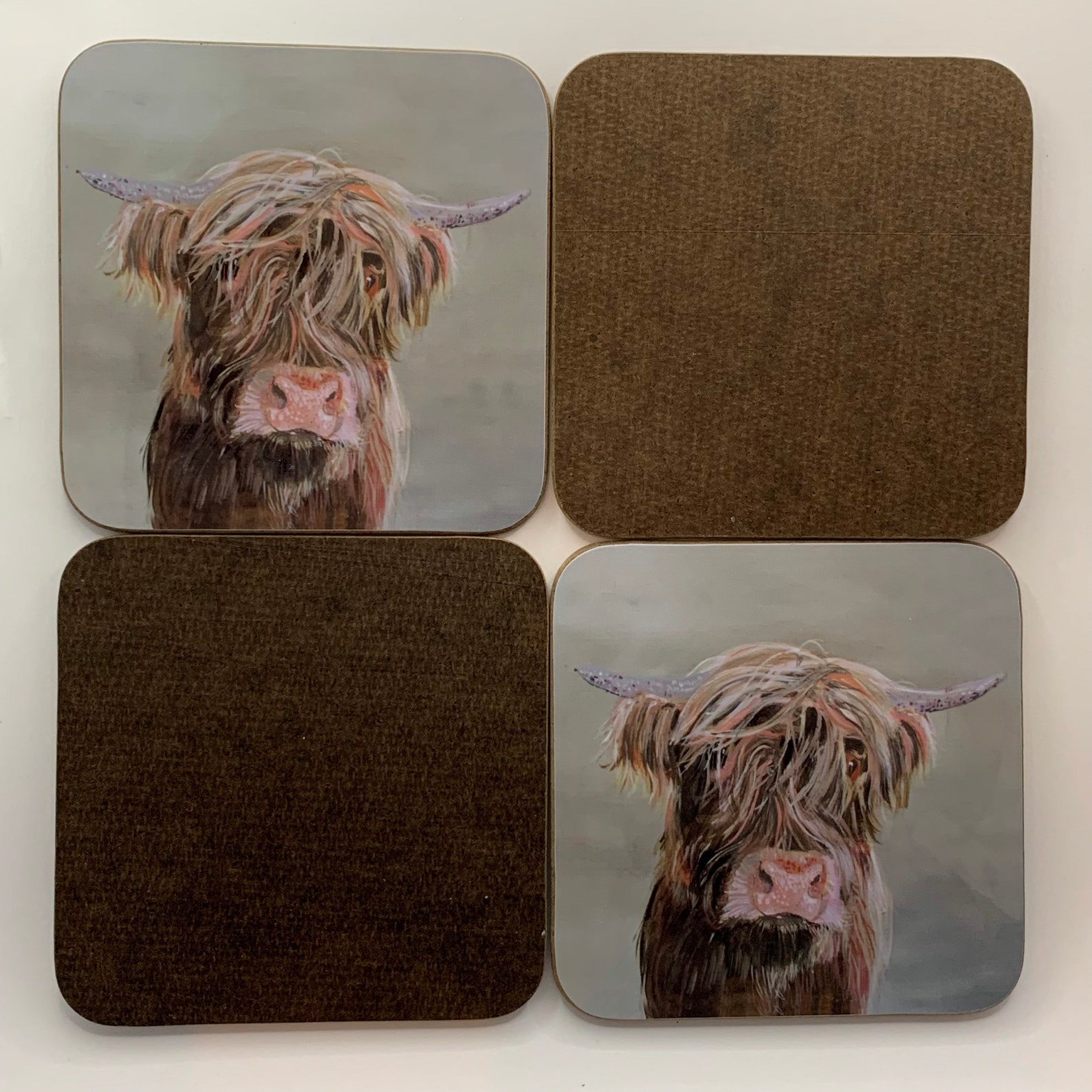 A set of four Highland Cow Coasters. Etsy