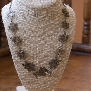 Flower and bees in antique brass with antique brass chain