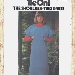 May include: A Butterick 4916 sewing pattern envelope for a TieOn! The Shoulder-Tied Dress in size Small. The cover features a photograph of a light blue sleeveless dress with shoulder ties worn over a red long-sleeved turtleneck shirt.