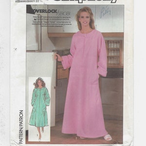 May include: Simplicity sewing pattern number 7815 for a long robe with a zipper closure. The pattern is for sizes small (10-12) and includes instructions for sewing on an overlock/serger or conventional machine.