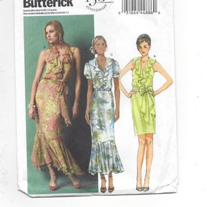 May include: Butterick B5879 sewing pattern featuring three dress designs. The pattern includes a halter dress with ruffles, a dress with a ruffled neckline and short sleeves, and a sleeveless dress with a bow. The pattern celebrates the 150th anniversary.