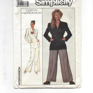 May include: Simplicity sewing pattern number 8857, size 8, for a double-breasted blazer and pants. The pattern features a black blazer with a white collar and a white pantsuit with a double-breasted blazer.
