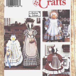 May include: Simplicity Crafts pattern 8462 featuring doll designs. The pattern includes instructions for creating several fabric dolls, each with unique outfits and accessories. The dolls are dressed in various styles, including aprons and bonnets.