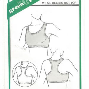 May include: A sewing pattern for a sleeveless top with a scoop neck and racerback design. The pattern is called "Mt. St. Helens Hot Top" and is from the Green Pepper Inc. brand. The pattern number is F792 and the price is $5.00.