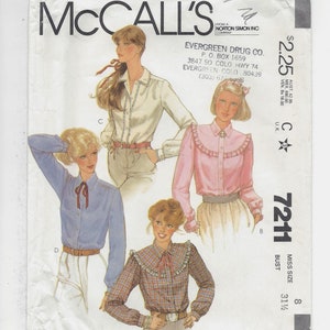 May include: A sewing pattern for a women's blouse with four different styles. The pattern is from McCall's and is for size 8, bust 31 1/2 inches. The pattern is called "7211".