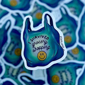 May include: A blue and green plastic grocery bag sticker with the text "I survived grocery shopping" and a yellow smiley face.