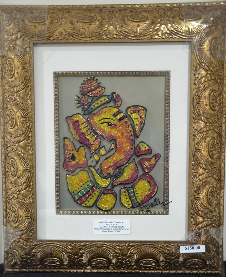 May include: A framed artwork depicting a colorful, glittery depiction of the Hindu deity Ganesha. The artwork is titled "Ganesha Collection" and is signed "Anjali".