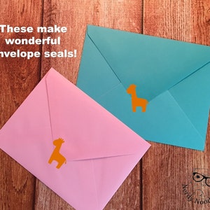 May include: Two envelopes with orange giraffe stickers on them. The text "These make wonderful envelope seals!" is in the top left corner of the image.