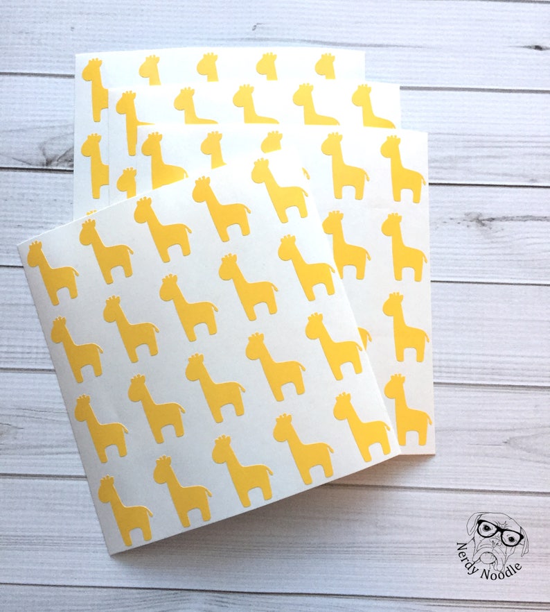 May include: Three sheets of white paper with a repeating pattern of yellow giraffe silhouettes.