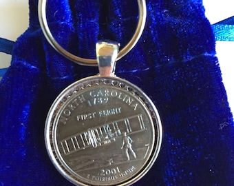 Llavero de moneda de 25 centavos de Carolina del Norte "Primer vuelo"