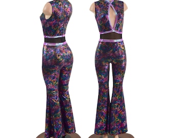 May include: A colorful, iridescent jumpsuit with a high neck, sleeveless design, and flared legs. The jumpsuit has a black mesh panel at the neckline and a pink trim around the waist.