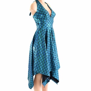 May include: A blue and black mermaid scale print halter dress with a high neckline and an asymmetrical hemline.