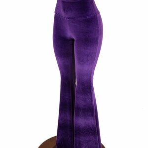 May include: Purple velvet bell bottom pants with a high waist.