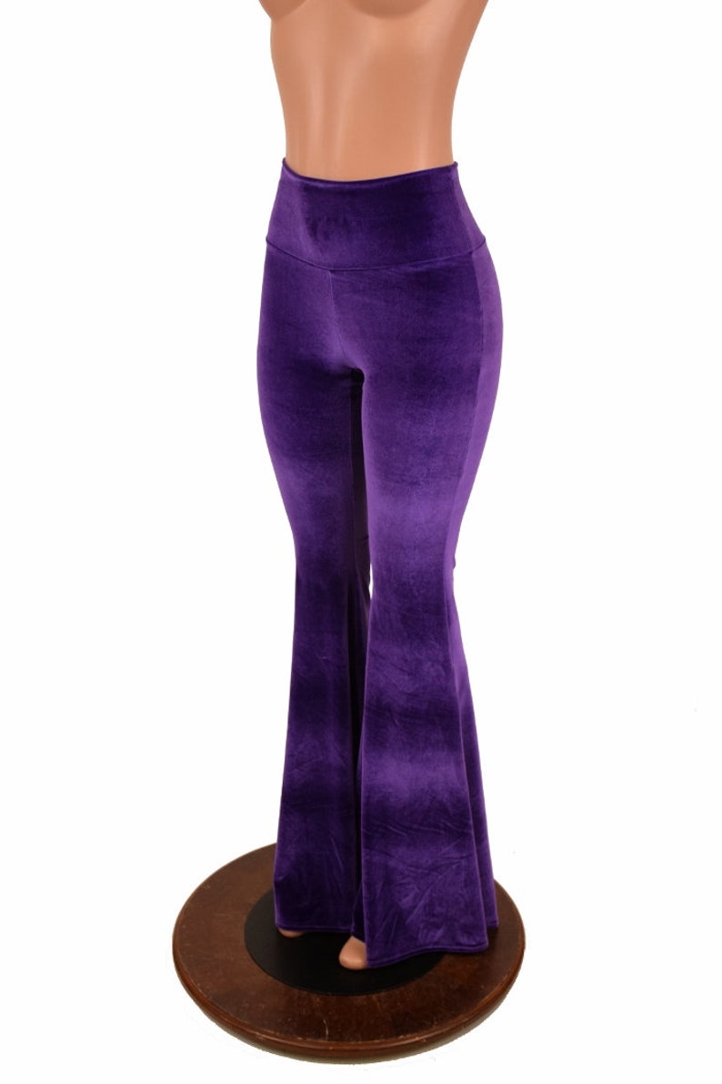 May include: Purple velvet bell bottom pants with a high waist.