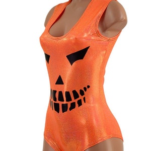 May include: Orange sleeveless bodysuit with a black jack-o'-lantern face printed on the front.