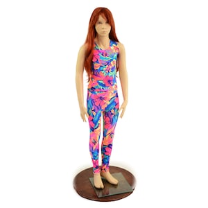 May include: A sleeveless tank top and leggings set with a tropical floral print in shades of pink, blue, and yellow. The outfit is on a mannequin with long red hair.