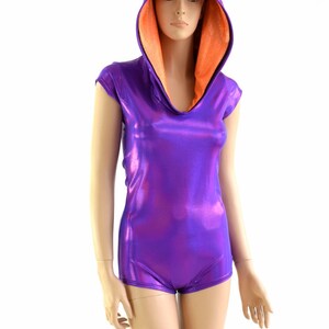 May include: A purple and orange hooded leotard with a pointed orange spike on the hood. The leotard is made of shiny fabric and has short sleeves.