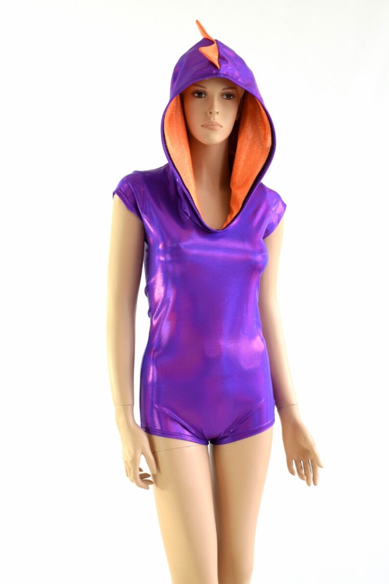 May include: A purple and orange hooded leotard with a pointed orange spike on the hood. The leotard is made of shiny fabric and has short sleeves.