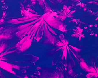 May include: A blue fabric with a pink floral pattern. The flowers are stylized and abstract, with a watercolor-like effect.