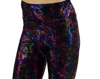 May include: Black cycling shorts with a holographic geometric pattern in shades of pink, blue, and gold.