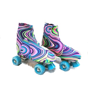 May include: A pair of roller skates with colorful swirl patterned covers. The skates have blue wheels and are on a white surface.