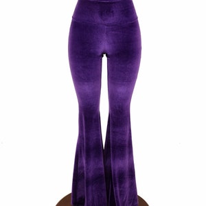 May include: Purple velvet bell bottom pants with a high waist.