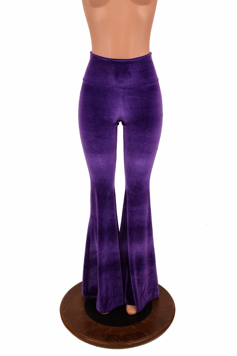 May include: Purple velvet bell bottom pants with a high waist.