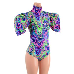 May include: A vibrant bodysuit with a high neck and short, puffed sleeves. The fabric features a swirling pattern in shades of blue, green, pink, and purple. The bodysuit is form-fitting and has a high-cut leg.