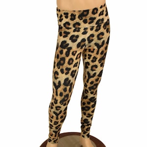May include: Leopard print leggings in brown and black. The leggings are on a mannequin.