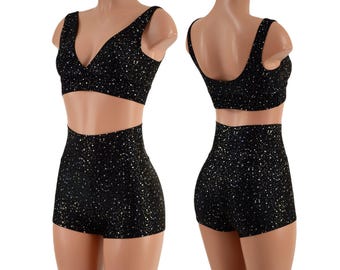 May include: Black crop top and high-waisted shorts with a sparkly, glittery pattern.