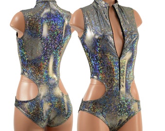May include: A silver holographic bodysuit with a high neck and a front zipper. The bodysuit has cutouts on the sides and a fitted silhouette.