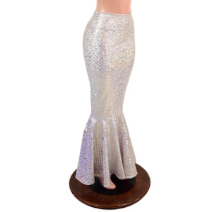 May include: A floor-length, high-waisted skirt featuring a shimmering, iridescent silver finish with a fine, repeating scale-like texture. The garment has a fitted silhouette through the hips and thighs, flaring out into a wide, ruffled hem.