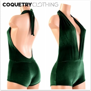 May include: A deep green velvet halter jumpsuit with a plunging neckline and a tie at the back.