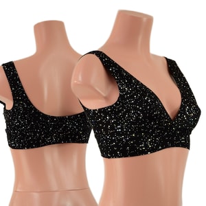 May include: Black bralette with a V-neck and a pattern of small, silver stars. The bralette has wide straps and is displayed on a mannequin. The fabric appears to be a soft, stretchy material.