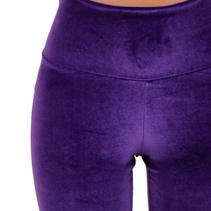 May include: Purple velvet leggings with a high waist.