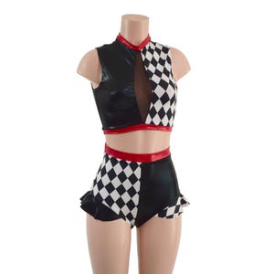 May include: A black and white checkered crop top with a red trim and a black high-waisted skirt with a ruffled hem and a red trim.