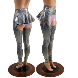 May include: Silver holographic leggings with a high-waisted skirt and thigh-high straps. The leggings have a shimmery, iridescent finish.
