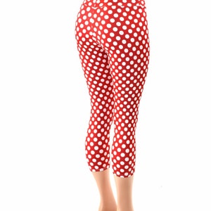 May include: Red and white polka dot leggings with a high waist. The leggings are cropped and end just below the knee.