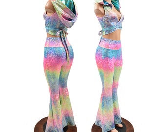 May include: A two-piece outfit featuring a rainbow tie-dye print with iridescent glitter. The top is a cropped, sleeveless top with a hood. The pants are bell-bottom style.