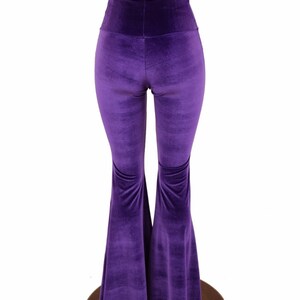 May include: Purple velvet bell bottom pants with a high waist.
