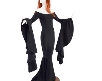 May include: A black off-the-shoulder dress with long, flared sleeves and a mermaid-style skirt. The dress is displayed on a mannequin with a red wig. The sleeves have a layered, cascading design.