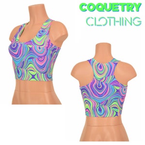 May include: A colorful crop top with a swirling psychedelic pattern in shades of purple, blue, green, and pink. The top features a racerback design and is displayed on a mannequin. The text "COQUETRY CLOTHING" is visible in the background.