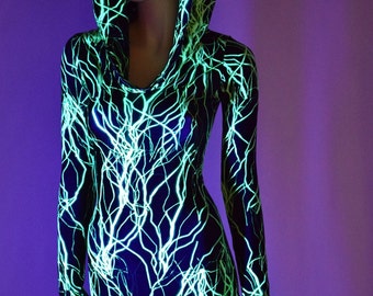 May include: A black and green hooded bodysuit with a lightning bolt pattern. The bodysuit is made of a shiny, stretchy fabric.