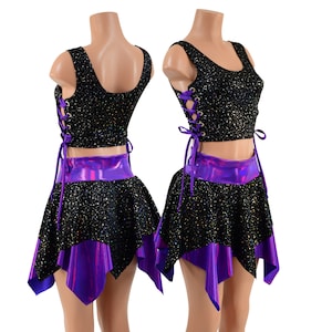 May include: Black crop top with purple lace-up detail and a matching black and purple skirt. The skirt has a flared, asymmetrical hemline.